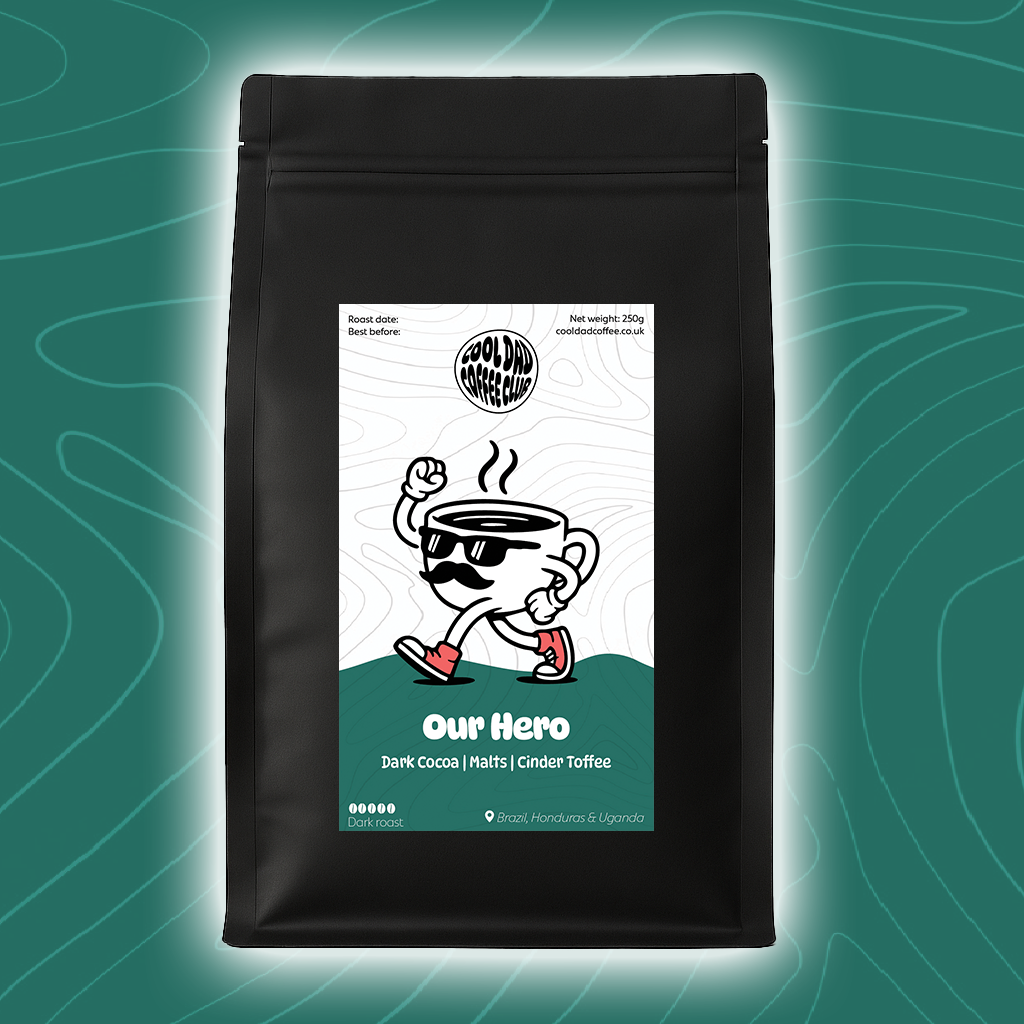 Black coffee bag with a cartoon character label on a teal background